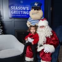 Girl sits on Santa's lap